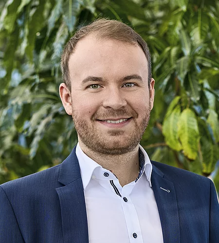 Felix Bartelt Mitarbeiter Rapunzel Presseteam vor Pflanzen.